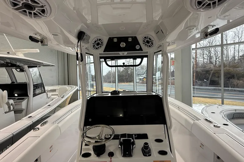 Slide: The Image of 2026 Sportsman Open 282 Center Console boat interior with steering wheel and controls. - 5
