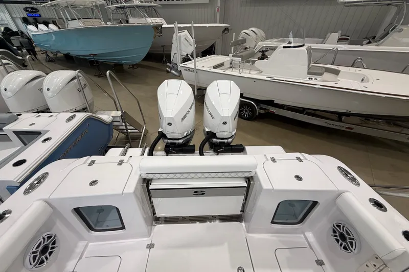 Slide: The Image of 2026 Sportsman Open 282 Center Console boat with dual Mercury engines in showroom. - 6