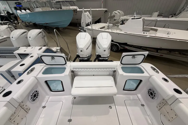 Slide: The Image of 2026 Sportsman Open 282 Center Console boat interior with dual engines and seating. - 8