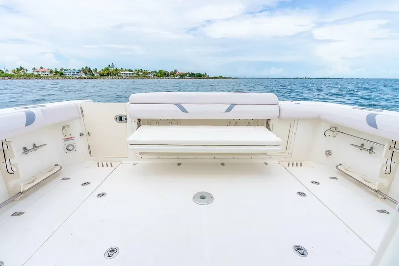 Slide: The Image of 2012 Boston Whaler 345 Conquest boat deck with ocean view and seating. - 19