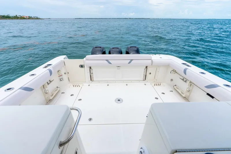 Slide: The Image of 2012 Boston Whaler 345 Conquest boat deck with ocean view and triple engines. - 23