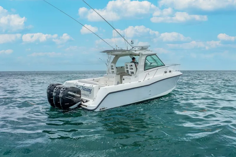 Slide: The Image of 2012 Boston Whaler 345 Conquest boat on open sea under blue sky. - 34