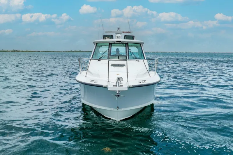 Slide: The Image of 2012 Boston Whaler 345 Conquest boat on open water under blue sky. - 37