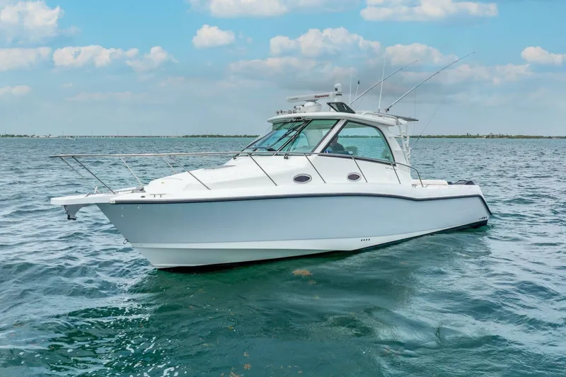 Slide: The Image of 2012 Boston Whaler 345 Conquest boat on open water under blue sky. - 38