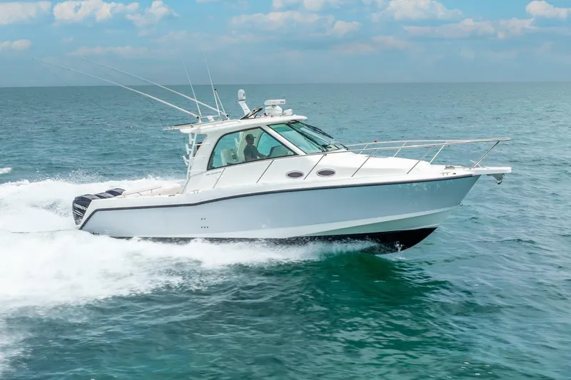 Slide: The Image of 2012 Boston Whaler 345 Conquest cruising on open water under a clear sky. - 42