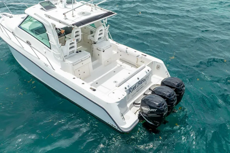 Slide: The Image of 2012 Boston Whaler 345 Conquest boat with triple Mercury engines on blue ocean. - 56