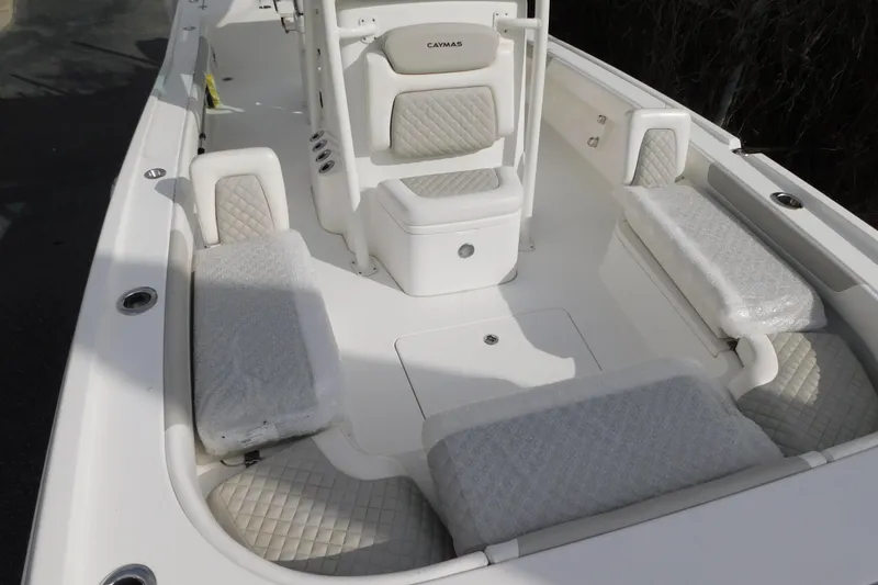 Slide: The Image of 2023 Caymas 28 HB boat interior with cushioned seating and storage compartments. - 14