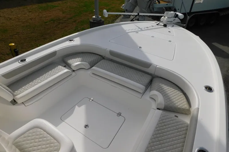 Slide: The Image of 2023 Caymas 28 HB boat with cushioned seating and storage compartments. - 15