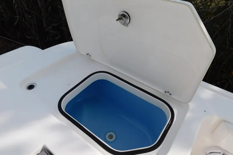 Slide: The Image of 2023 Caymas 28 HB boat livewell with open lid, showcasing interior design. - 18