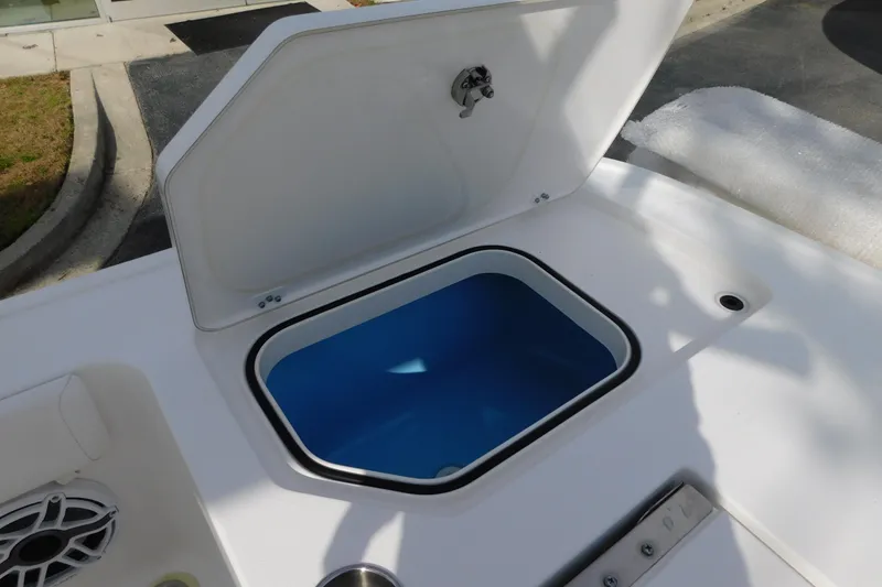 Slide: The Image of 2023 Caymas 28 HB boat with open storage compartment on deck. - 19