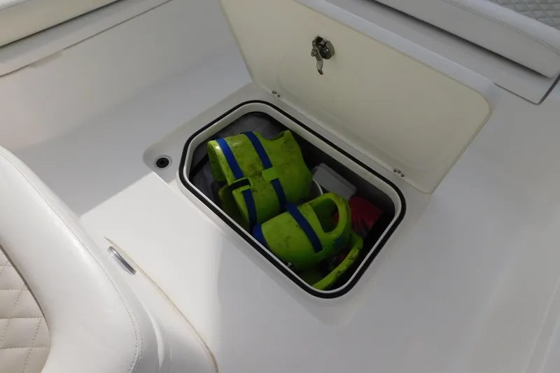 Slide: The Image of Storage compartment on 2023 Caymas 28 HB boat with life jackets inside. - 20