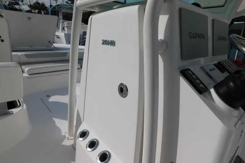 Slide: The Image of 2023 Caymas 28 HB boat interior with Garmin navigation system and seating area. - 24