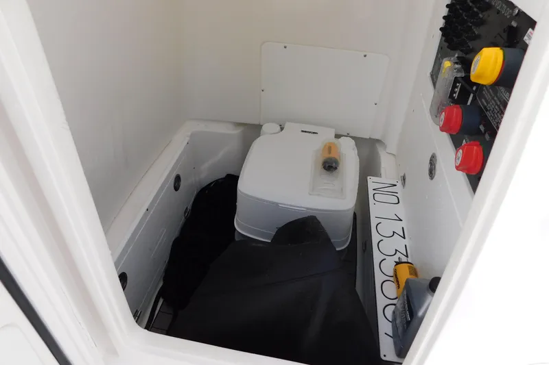 Slide: The Image of 2023 Caymas 28 HB boat interior storage compartment with equipment and controls. - 29