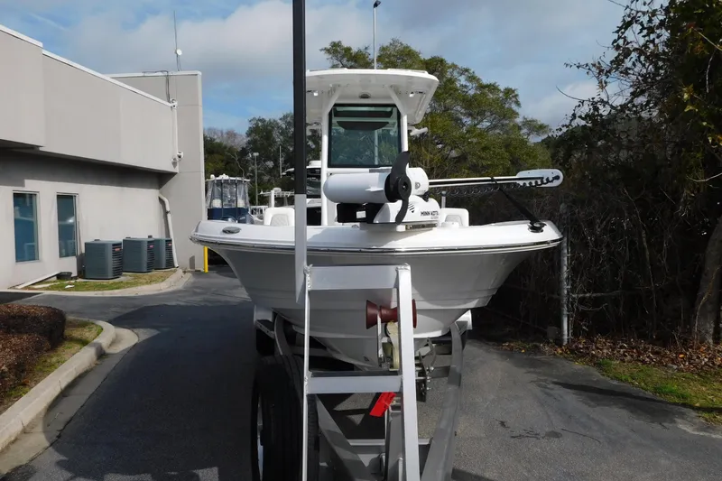 Slide: The Image of 2023 Caymas 28 HB boat on trailer, parked outdoors near a building. - 30