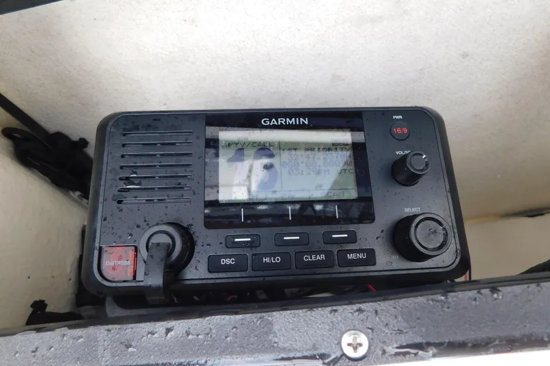 Slide: The Image of Garmin marine radio on 2023 Caymas 28 HB boat, displaying channel 16. - 34