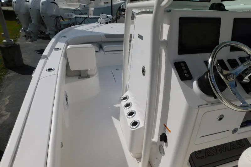 Slide: The Image of 2023 Caymas 28 HB boat interior with steering console and seating area. - 4