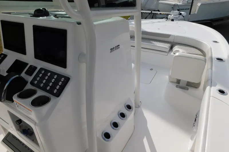 Slide: The Image of 2023 Caymas 28 HB boat interior with control panel and seating area. - 40
