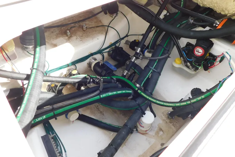 Slide: The Image of 2023 Caymas 28 HB boat interior showing complex wiring and plumbing system. - 41