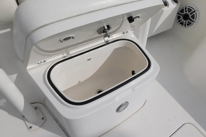 Slide: The Image of 2023 Caymas 28 HB boat storage compartment with open lid, showcasing interior space. - 7