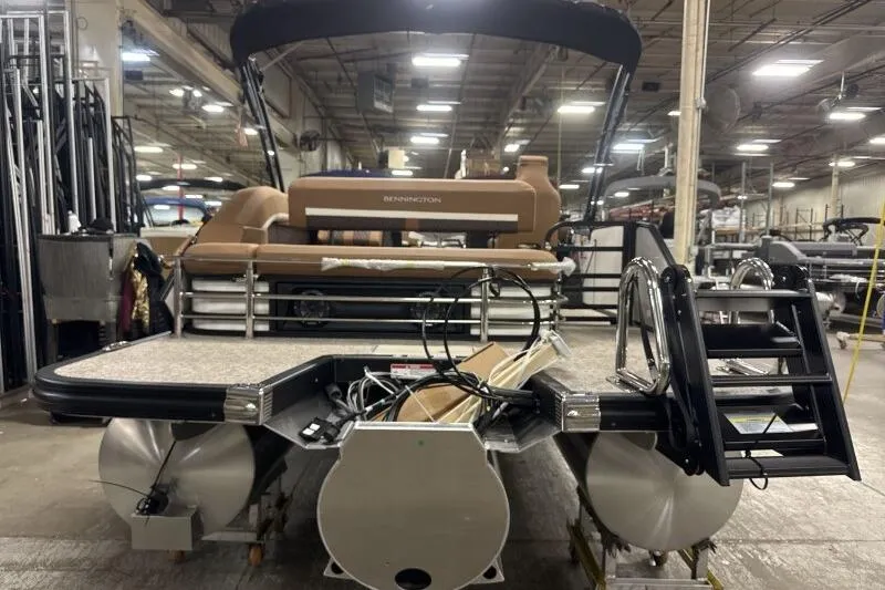 Slide: The Image of 2026 Bennington 22 MSBSF pontoon boat in a factory setting, rear view. - 15