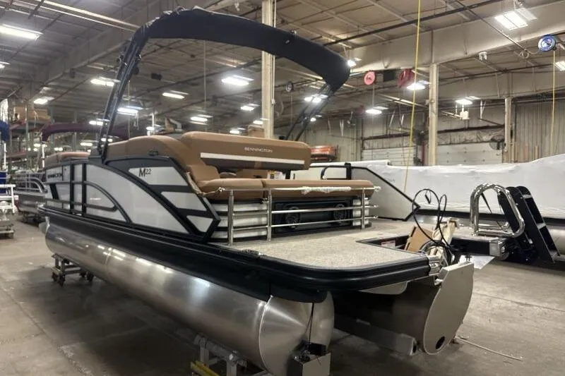 Slide: The Image of 2026 Bennington 22 MSBSF pontoon boat in a warehouse setting. - 5