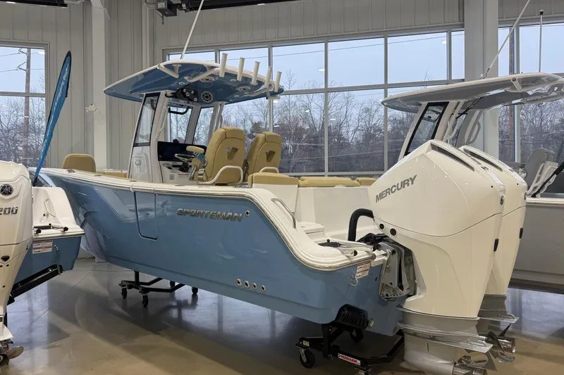 The Image of 2026 Sportsman Heritage 261 Center Console boat with dual Mercury engines in showroom. - 27