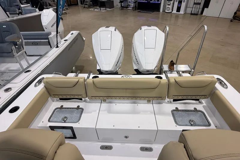 Slide: The Image of 2026 Sportsman Heritage 261 Center Console boat with dual Mercury engines, beige seating, and fishing amenities. - 29