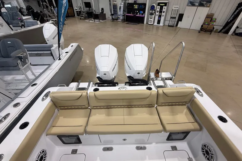 Slide: The Image of 2026 Sportsman Heritage 261 Center Console boat interior with dual engines and beige seating. - 30