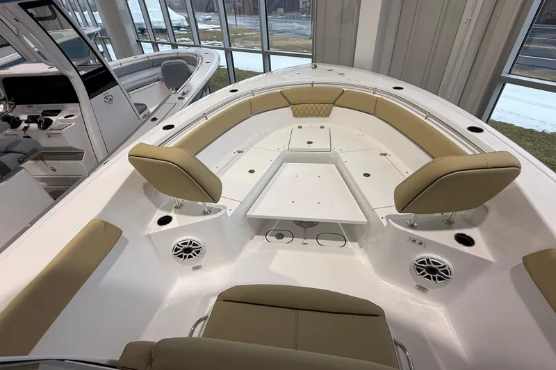 Slide: The Image of 2026 Sportsman Heritage 261 Center Console boat interior with tan seating and modern design. - 32
