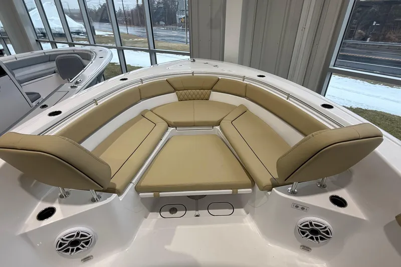 Slide: The Image of 2026 Sportsman Heritage 261 Center Console boat with tan cushioned seating in showroom. - 33