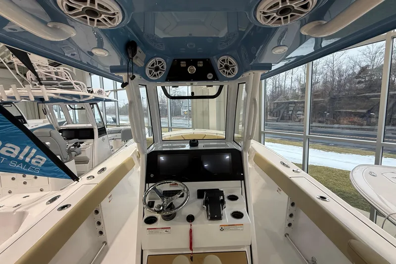 Slide: The Image of 2026 Sportsman Heritage 261 Center Console boat interior with modern controls and speakers. - 35