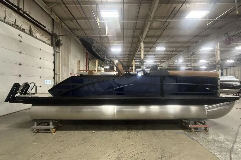 Slide: The Image of 2026 Bennington 22 MSBSF pontoon boat in a warehouse setting. - 1