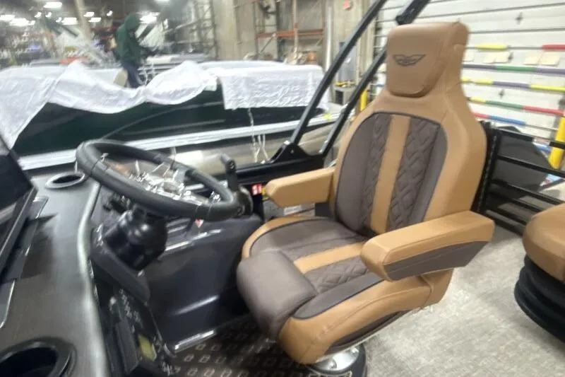 Slide: The Image of Captain's chair and steering wheel of 2026 Bennington 22 MSBSF boat in a workshop. - 16