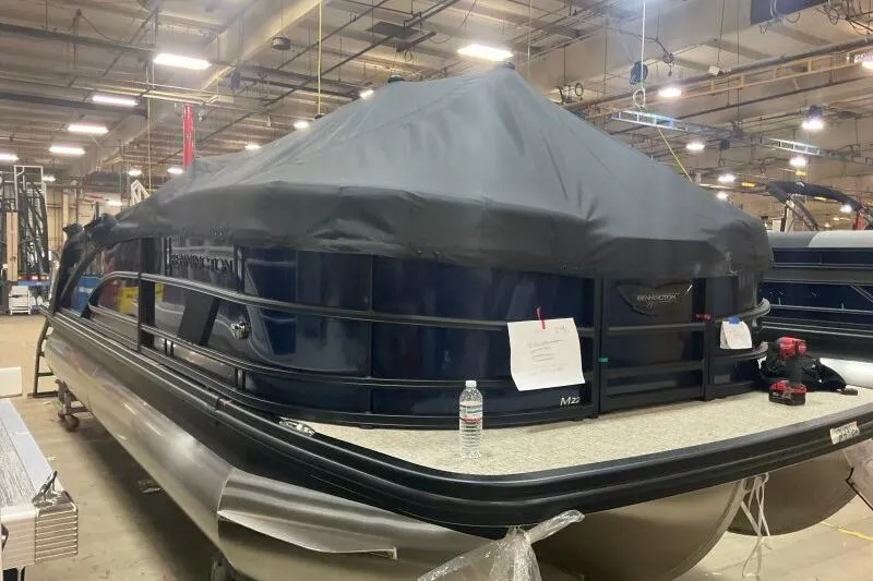 Slide: The Image of 2026 Bennington 22 MSBSF pontoon boat covered in a warehouse setting. - 19