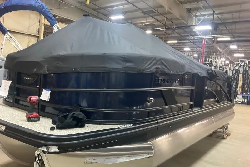 Slide: The Image of 2026 Bennington 22 MSBSF pontoon boat covered in a warehouse setting. - 20