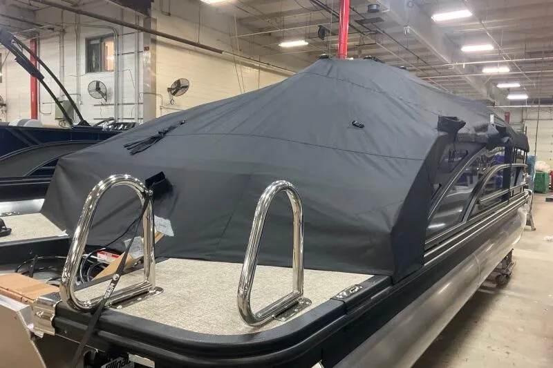 Slide: The Image of 2026 Bennington 22 MSBSF pontoon boat with cover in a warehouse setting. - 21