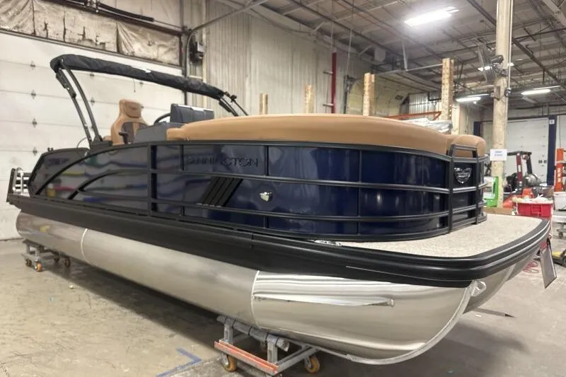 Slide: The Image of 2026 Bennington 22 MSBSF pontoon boat in a warehouse setting. - 5
