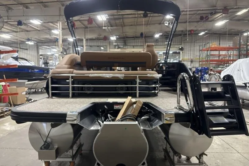 Slide: The Image of 2026 Bennington 22 MSBSF pontoon boat in a factory setting, rear view. - 8