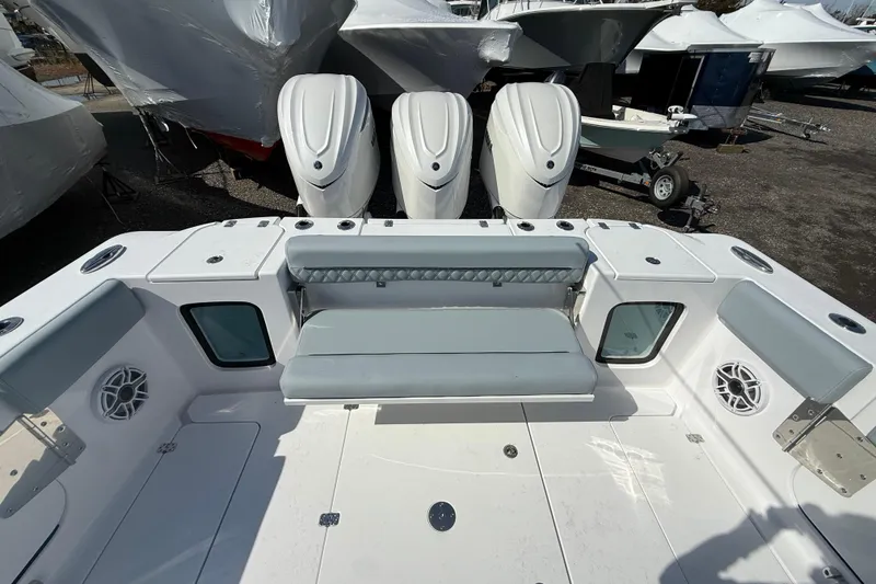 Slide: The Image of 2026 Sportsman Open 352 Center Console boat with triple outboard engines and spacious seating. - 22