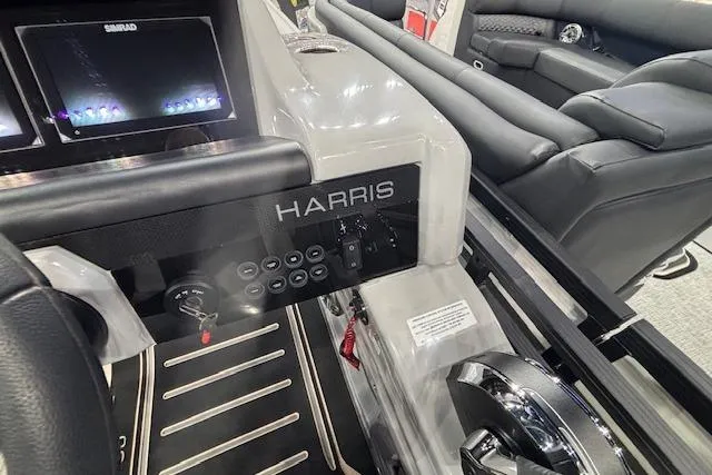 Slide: The Image of 2026 Harris Solstice 230 CWDH boat interior with control panel and seating. - 21