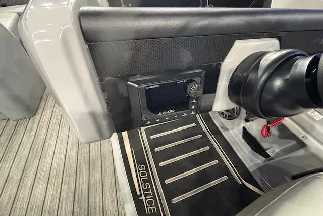 Slide: The Image of Interior of 2026 Harris Solstice 230 CWDH boat with audio controls and branded flooring. - 23
