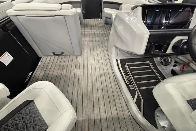 Slide: The Image of 2026 Harris Solstice 230 CWDH interior with modern seating and sleek dashboard design. - 24