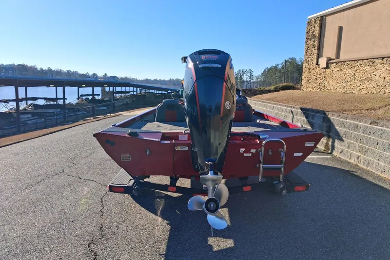 Slide: The Image of 2023 Ranger RT188 boat with outboard motor, parked near a lakeside dock. - 4