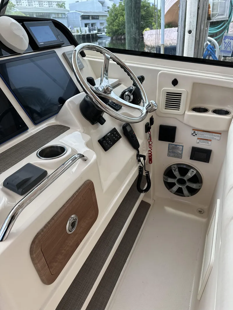 Slide: The Image of 2017 Grady-White Freedom 375 boat helm with steering wheel and control panel. - 15