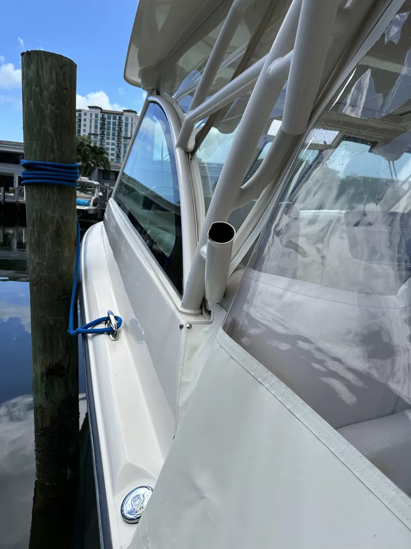 Slide: The Image of 2017 Grady-White Freedom 375 boat docked, side view with clear skies. - 33