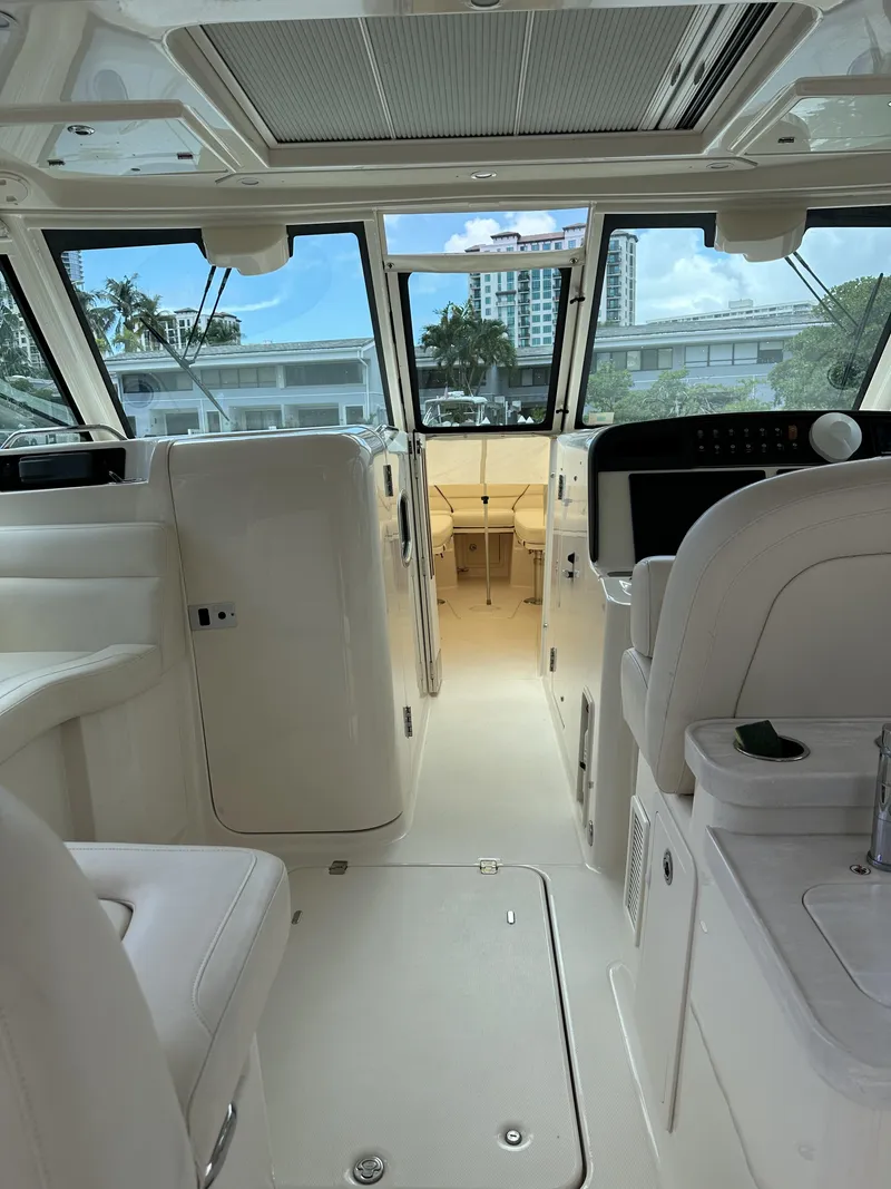 Slide: The Image of Interior of 2017 Grady-White Freedom 375 boat, featuring spacious seating and modern controls. - 37