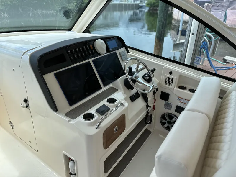 Slide: The Image of 2017 Grady-White Freedom 375 helm with dual screens and steering wheel. - 42
