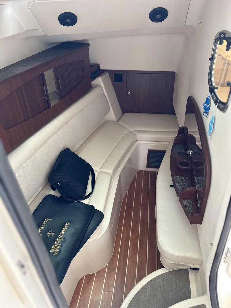 Slide: The Image of 2017 Grady-White Freedom 375 cabin interior with white seating and wood accents. - 45