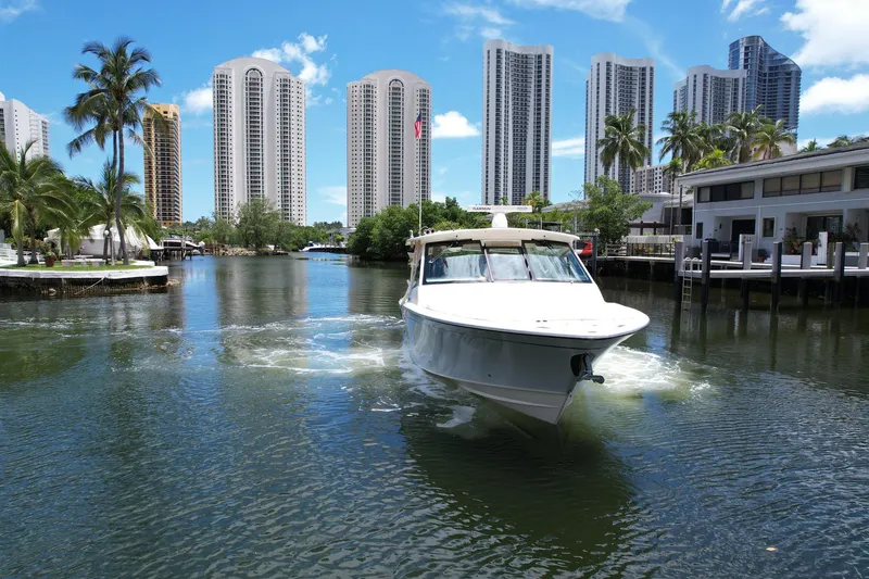 Slide: The Image of 2017 Grady-White Freedom 375 boat cruising in a city canal with skyscrapers. - 8