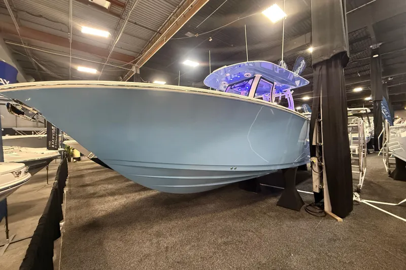 The Image of 2026 Sportsman Open 302 Center Console boat displayed indoors at a boat show. - 0